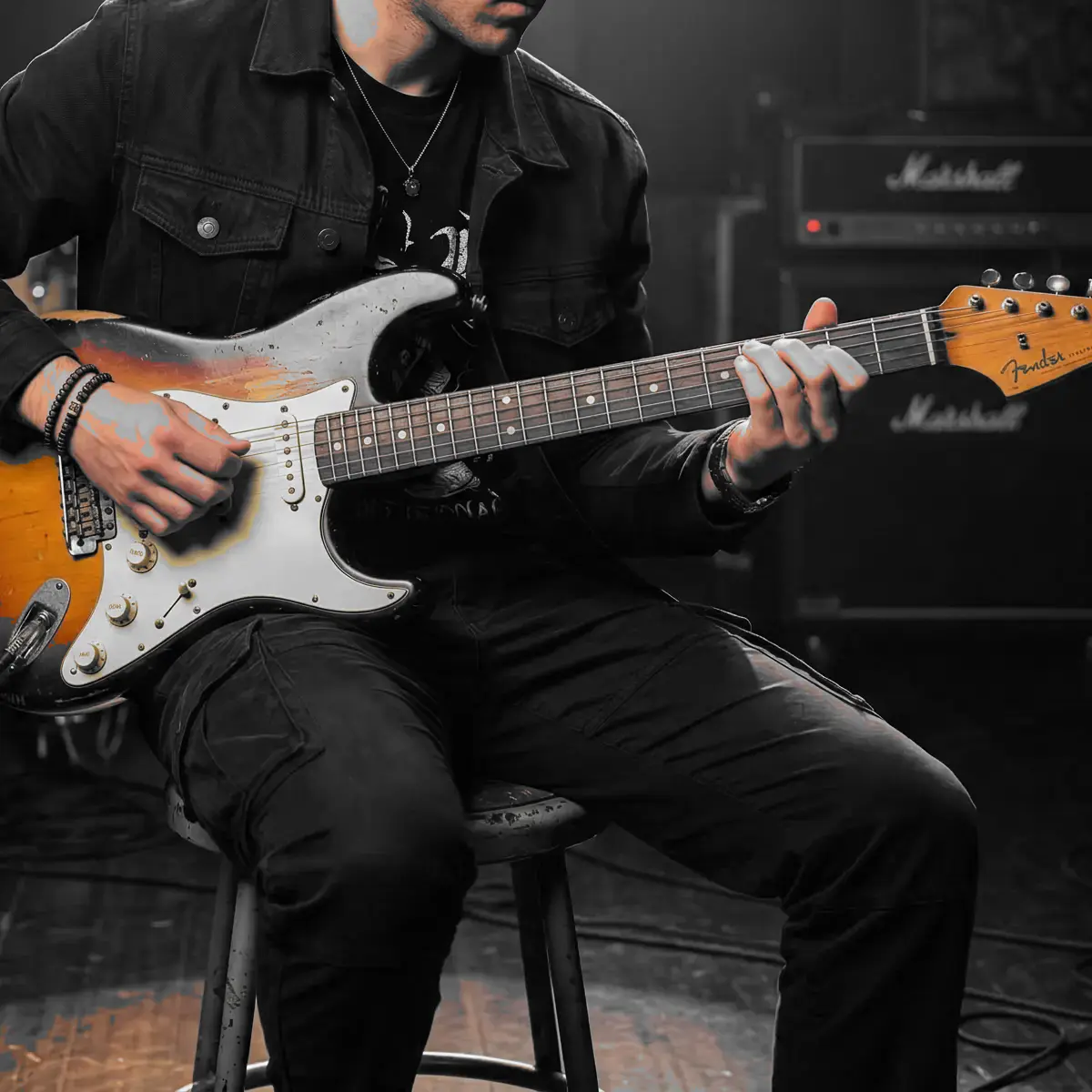 Guitar detail crop with the warm sunburst body preserved as the focal color accent